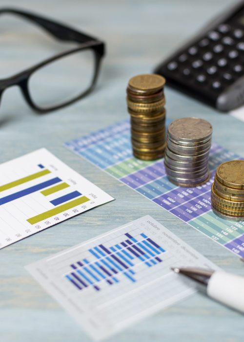reading-glasses-piles-coins-high-view